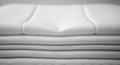Stack of neatly folded white towels or linens, featuring a smooth texture with visible weave Royalty Free Stock Photo