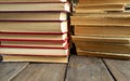 A stack of new books next to old ones. Books of different generations are stacked in two piles. Two stacks of books. Royalty Free Stock Photo