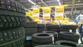 Stack of new snow tires for sale in supermarket. Studded tyres. Discount. Professional car service and repair. Get vehicle wheel r