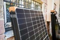 Stack of new solar panels with protective cardboard, ready for installation. Royalty Free Stock Photo