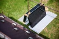 Stack of new solar panels with protective cardboard, ready for installation. Royalty Free Stock Photo