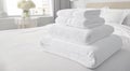 Stack of new white bath towels on bed in hotel room waiting for new guests.Macro.AI Generative Royalty Free Stock Photo