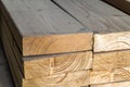 Stack of new wooden studs at the lumber yard. Wood timber construction material. Shallow depth of field effect Royalty Free Stock Photo