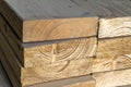 Stack of new wooden studs at the lumber yard. Wood timber construction material. Shallow depth of field effect Royalty Free Stock Photo