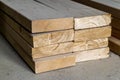 Stack of new wooden studs at the lumber yard. Wood timber construction material. Shallow depth of field effect Royalty Free Stock Photo