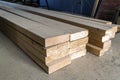 Stack of new wooden studs at the lumber yard. Wood timber construction material. Shallow depth of field effect Royalty Free Stock Photo