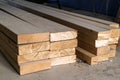 Stack of new wooden studs at the lumber yard. Wood timber construction material. Shallow depth of field effect Royalty Free Stock Photo
