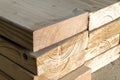 Stack of new wooden studs at the lumber yard. Wood timber construction material. Shallow depth of field effect Royalty Free Stock Photo