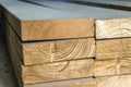 Stack of new wooden studs at the lumber yard. Wood timber construction material. Shallow depth of field effect Royalty Free Stock Photo