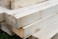 Stack of new wooden studs at the lumber yard. Wood timber construction material. Shallow depth field effect Royalty Free Stock Photo