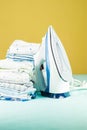 Stack of newborn baby clothes pressed with an electric iron Royalty Free Stock Photo