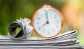 Stack of newspapers with alarm clock, daily news background Royalty Free Stock Photo