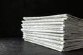 Stack of newspapers on dark table. Journalist`s work Royalty Free Stock Photo
