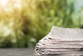 Stack of newspapers on table against blurred green background, space for design. Journalist`s work Royalty Free Stock Photo