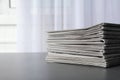 Stack of newspapers on grey table, space for text. Journalist`s work Royalty Free Stock Photo