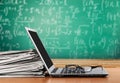 Stack of newspapers with laptop on wooden table Royalty Free Stock Photo