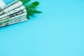 Stack newspapers with leaves on blue background. Royalty Free Stock Photo
