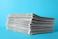 Stack of newspapers on blue background. Journalist`s work Royalty Free Stock Photo