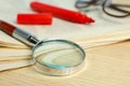 Stack of newspapers, magnifier, marker and glasses on table. Search concept Royalty Free Stock Photo
