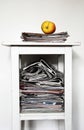 Stack of newspapers on the nightstand and an apple Royalty Free Stock Photo