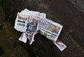 Stack of newspapers on the pavement outdoors Royalty Free Stock Photo