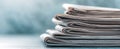 The stack of newspapers resting on a light blue surface..AI generated image Royalty Free Stock Photo