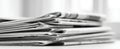 The stack of newspapers showcasing daily news and information in black and white..AI generated image Royalty Free Stock Photo