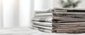 The stack of newspapers sitting neatly on a table in natural light. AI generated image Royalty Free Stock Photo