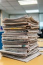 A stack of newspapers sitting on top of a table Royalty Free Stock Photo