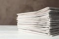 Stack of newspapers on white table. Journalist`s work Royalty Free Stock Photo