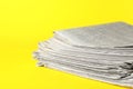 Stack of newspapers on yellow background. Journalist`s work Royalty Free Stock Photo