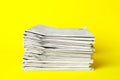 Stack of newspapers on yellow. Journalist`s work Royalty Free Stock Photo