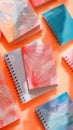 Stack of notebooks in various colors and patterns on table Royalty Free Stock Photo