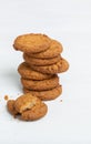 Stack of oatmeal cookies lies on a white table. Concept of low-calorie desserts and a healthy snack. Sweet culinary.