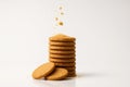Stack of oatmeal digestive biscuits dynamic sprinkle of crumbs falling mid air above the stack on white Royalty Free Stock Photo