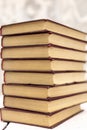 Stack of old ancient shabby books on a white wooden background