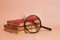 A stack of old battered books tied with a jute rope and a magnifying glass Royalty Free Stock Photo