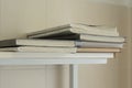 A stack of old battered work logs on a wooden shelf