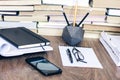 Stack of old book on wooden table, laptop computer, notebook, smartphone, stationery and paperweight. Education writer concept Royalty Free Stock Photo
