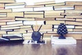 Stack of old book on wooden table, laptop computer, notebook, smartphone, stationery and paperweight. Education writer concept Royalty Free Stock Photo