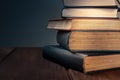 A stack of old books against a dark background with copy space Royalty Free Stock Photo