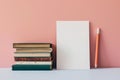 Stack of old books beside a blank sheet and pencil, ready for original writing or the pitfalls of plagiarism