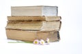 A stack of old books. bouquet of flowers from daisies on a white background Royalty Free Stock Photo