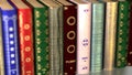 A stack of old books. Camera movement along an endless shelf of books. Looped 4K video