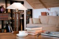 Stack of old books, close laptop and cup with coffee over wooden table, retro filtered image Royalty Free Stock Photo