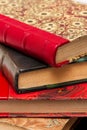 Stack of old books with colorful ancient bindings