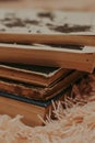 A stack of old books on a cozy fluffy beige blanket. Place for text.