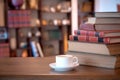 Stack of old books and cup with coffee over wooden table, retro filtered image Royalty Free Stock Photo
