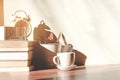 Stack old books with a cup of freshly coffee, vintage alarm clockon, wooden calendar, on table in sunlight morning, Start up Royalty Free Stock Photo