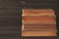 Stack of old books on dark wooden background Royalty Free Stock Photo